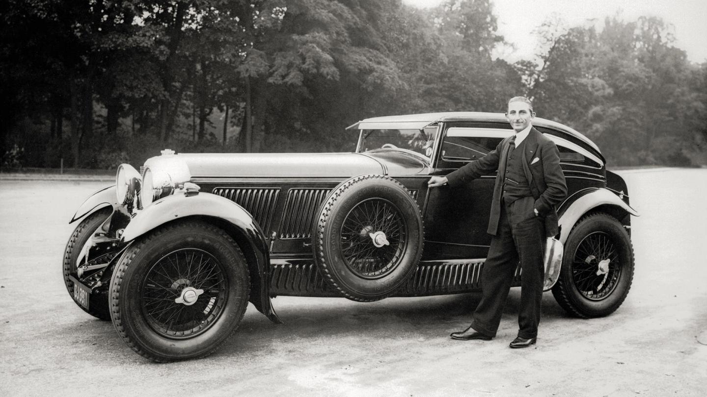 Woolf Barnatos chauffer stood alongside the Blue Train 8 Litre Bentley