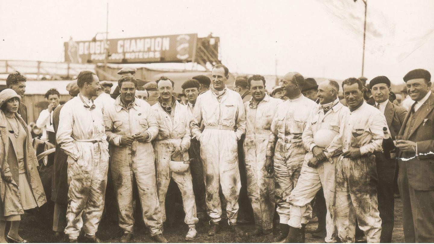 All eight Bentley Boys in racing overalls stood next to one another preparing for Le Mans