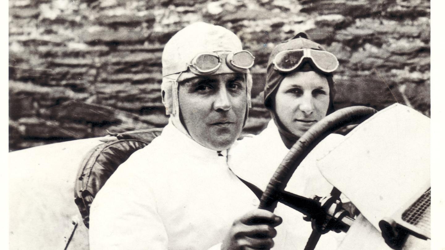 W.O. Bentley sat in a racing Bentley with lead mechanic Nobby Clarke