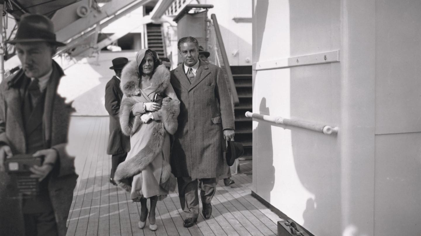 Woolf and Diana Barnato arriving in Britain dressed in formal attire