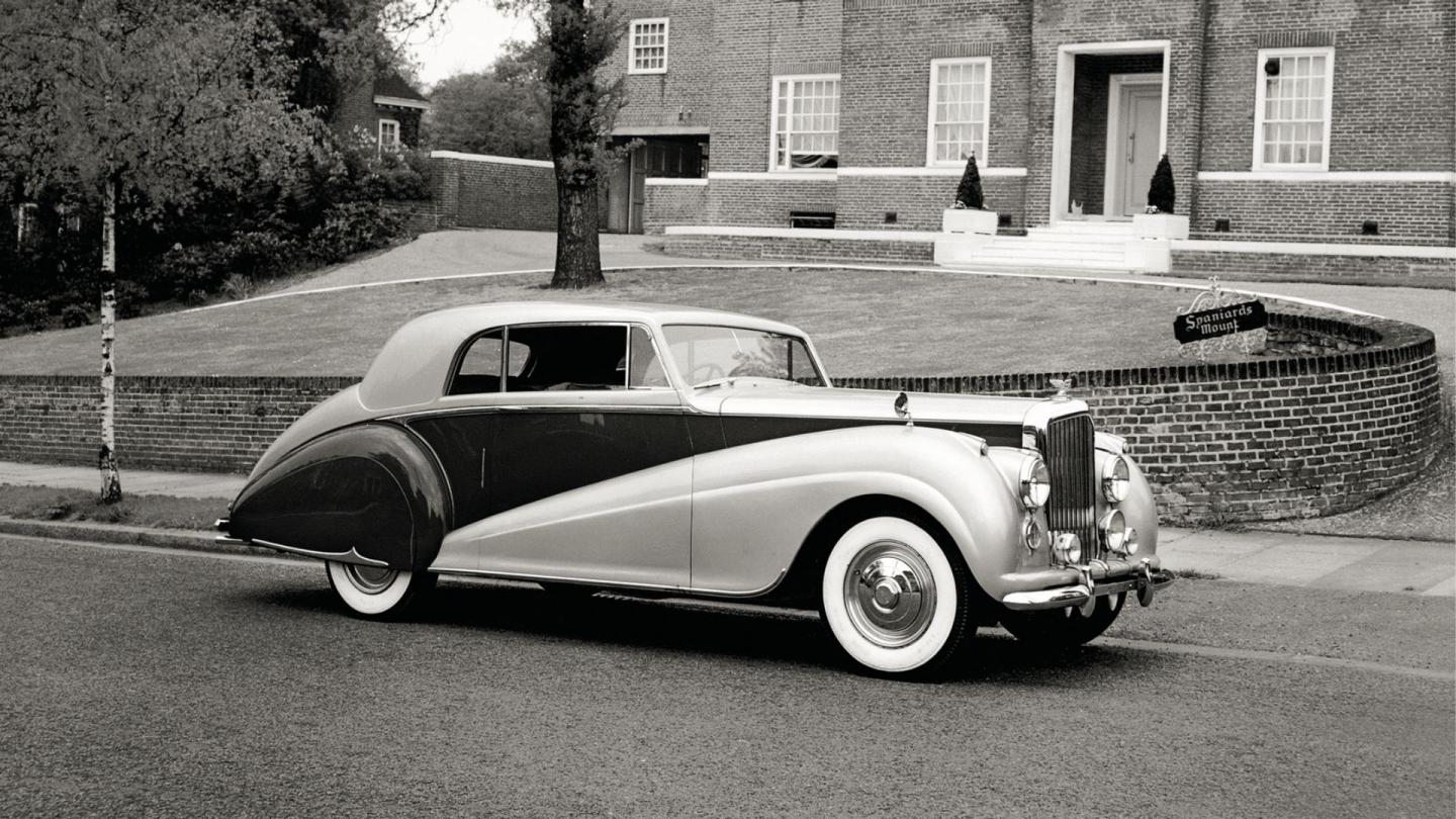 Front three quarter of a duo tone Bentley Mark VIparked in front of Spaniards Mound in London