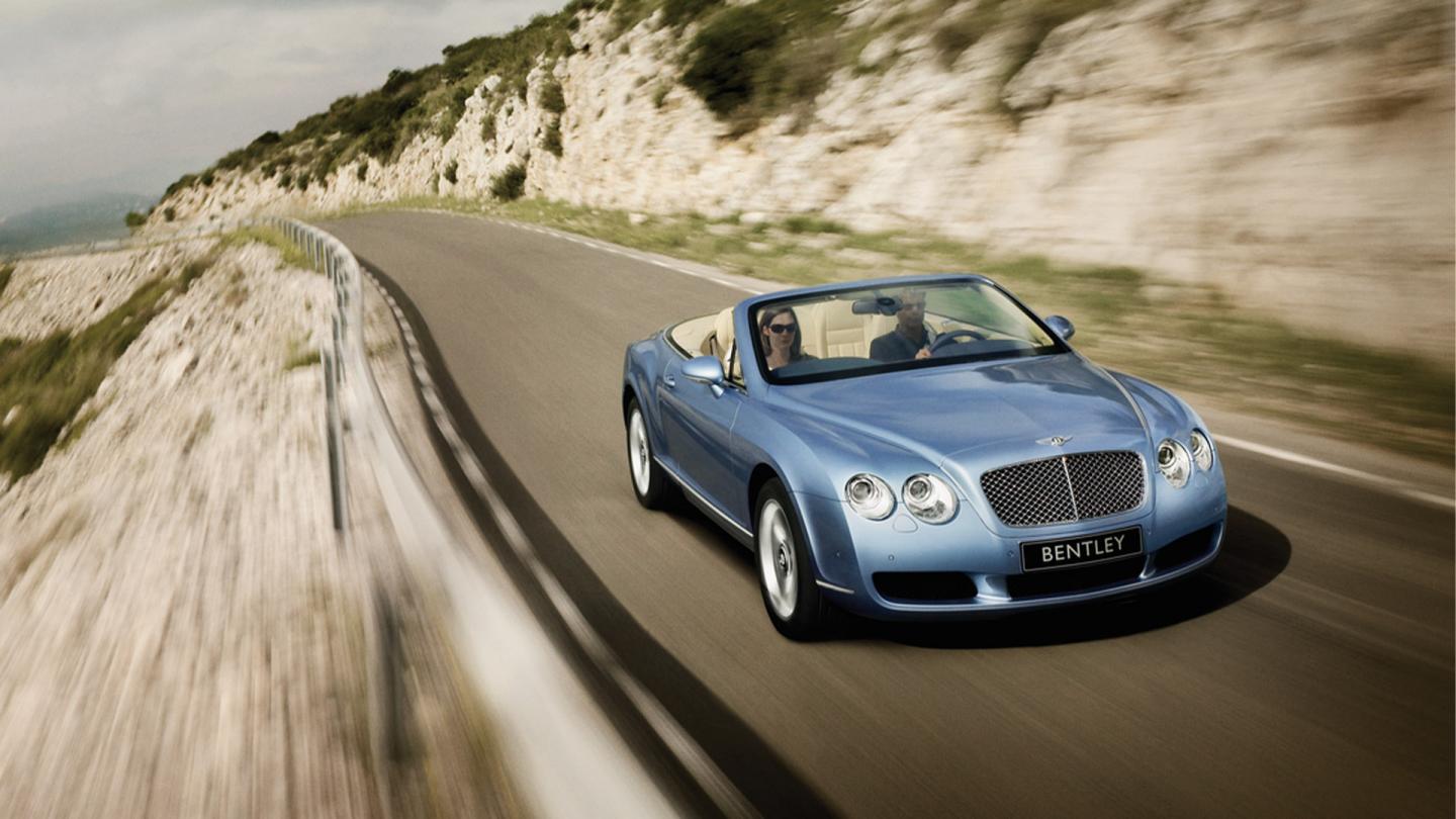 A front three quarter product launch image of the first generation Continental GT Convertible in a riviera blue exterior paint colour