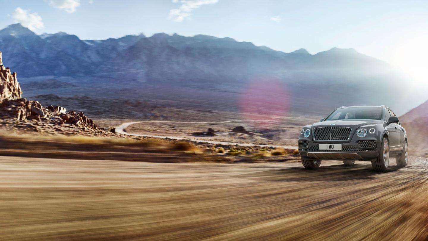 The first ever luxury SUV, the first generation Bentley Bentayga driving in a desert