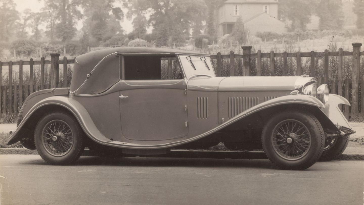 Front three quarter of the Bentley 4 Litre in an urban environment and sporting cream/pale white coachwork