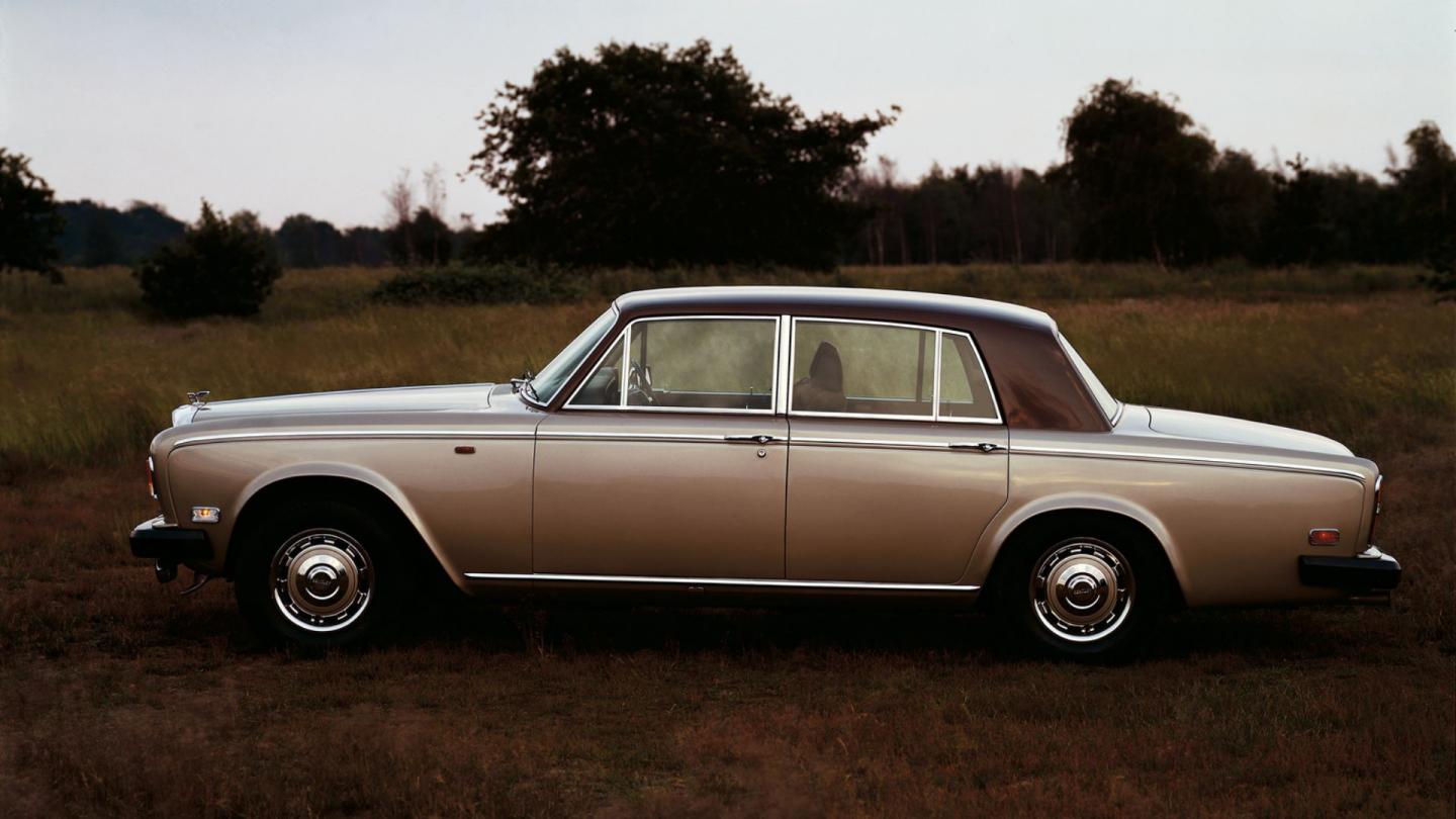 Side profile of a bronze duo tone Bentley T-Series in a rural environment
