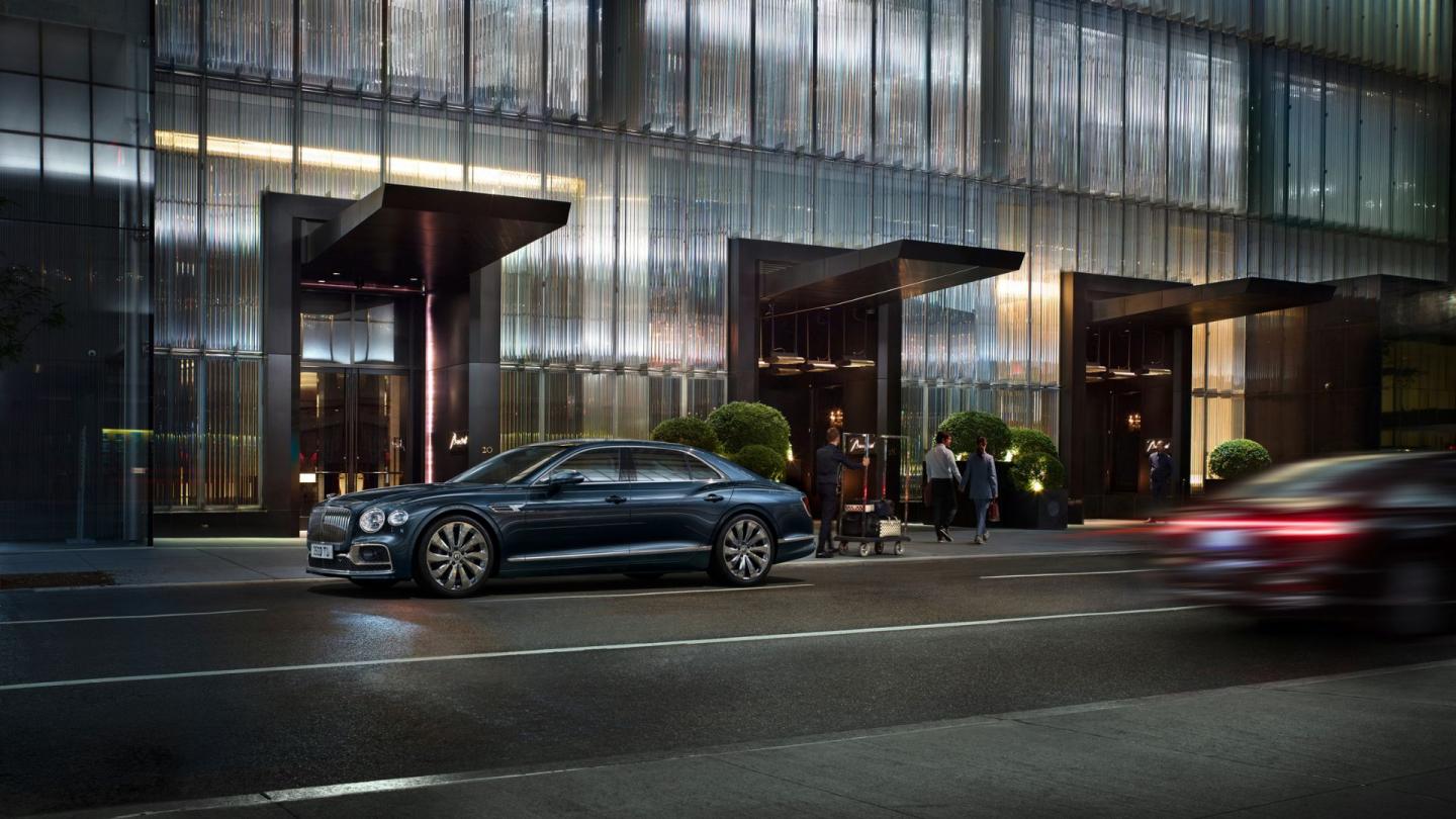 The third generation of the luxurious Flying Spur parked in front of a modern hotel in London