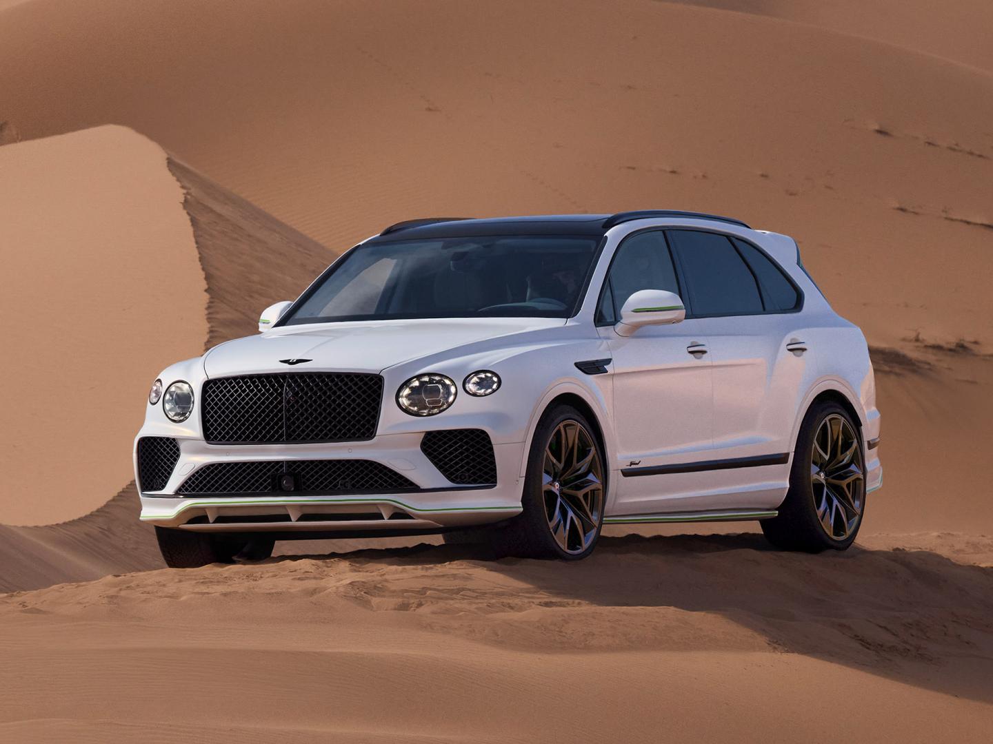 New Bentayga Speed in Snow Quartz by Mulliner exterior paint with the Bentayga Styling Specification and 23" Directional Wheels driving on sand dunes.