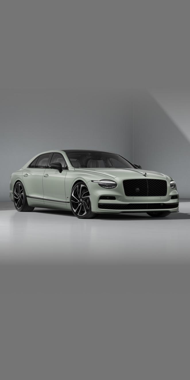 Front three-quarter of the Bentley Flying Spur S in Opalite showing the headlights, Carbon Styling Spec and 22" Ten Swept Spoke Black & Machined wheel.