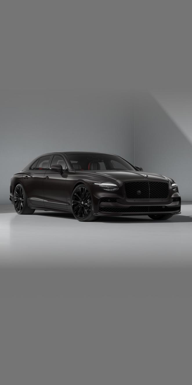 Front three-quarter of the Bentley Flying Spur Speed in Black Velvet showing the headlights and 22" Speed Wheel painted in black.