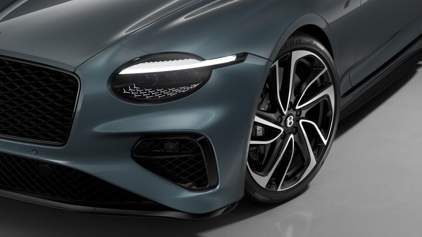 Close up of the headlights on the Bentley Continental GT S in Thunder, shown with 22" Ten Swept Spoke Wheel painted Black and Bright Machined.