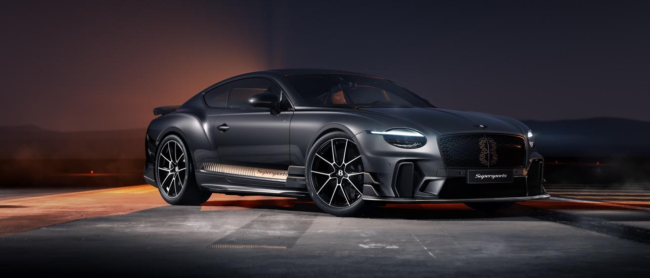 Front three quarter of the Bentley Supersports in Nightfall specification doing a rolling burnout on a runway