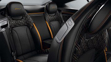 Bentley Continental GT Speed rear seats featuring Beluga hide contrasted by Mandarin piping and contrast Speed Emblem stitching. 