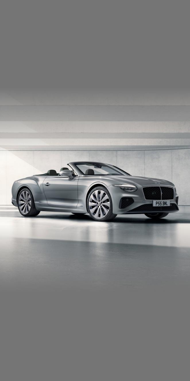 Front side angled view of Bentley Continental GTC Mulliner W 12 in Tanzanite purple colour, featuring 22 inch Mulliner Wheel Painted and Mulliner double diamond radiator grille - Black