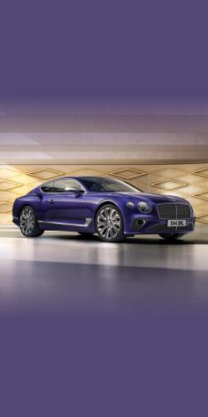Front side angled view of Bentley Continental GT Mulliner W12 in Tanzanite Purple colour, featuring 22 inch Mulliner Wheel Painted and Mulliner double diamond radiator grille - Black.