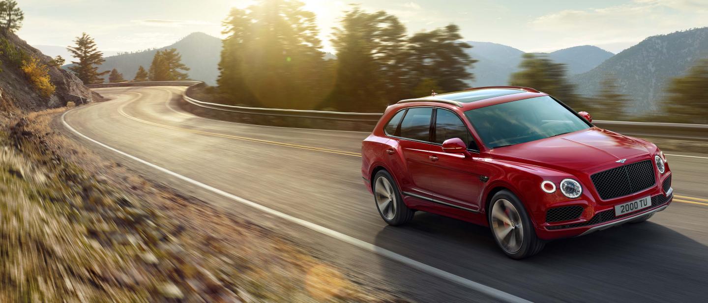 A 2021 Bentley Bentayga driving in rural environments