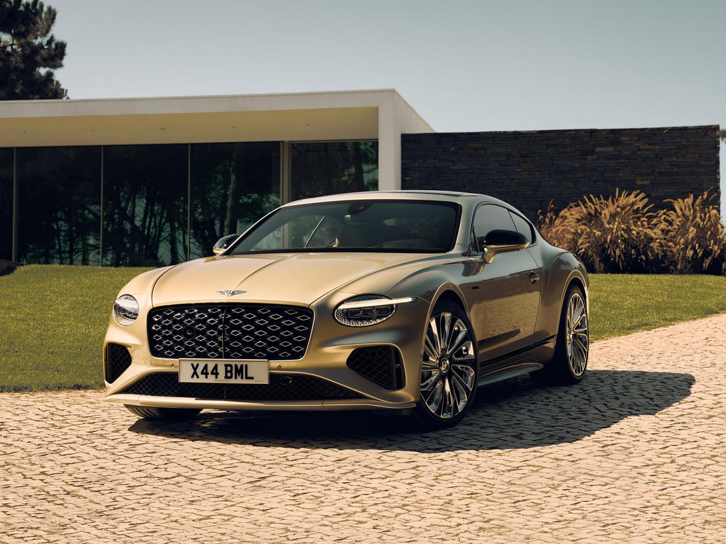 Front three quarter of the new hybrid Bentley Continental GT Mulliner with a Patina exterior colour and exclusive Mulliner 22" directional wheels