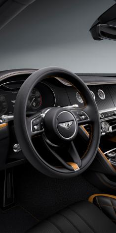 Interior view of Bentley Flying Spur Speed overlookingHeated, Single Tone, 3 Spoke, Indented Hide Trimmed Steering Wheel with Bentley insignia.