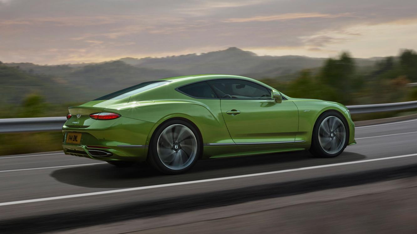 The new Bentley Continental GT Speed in Tourmaline Green driving in a rural environment