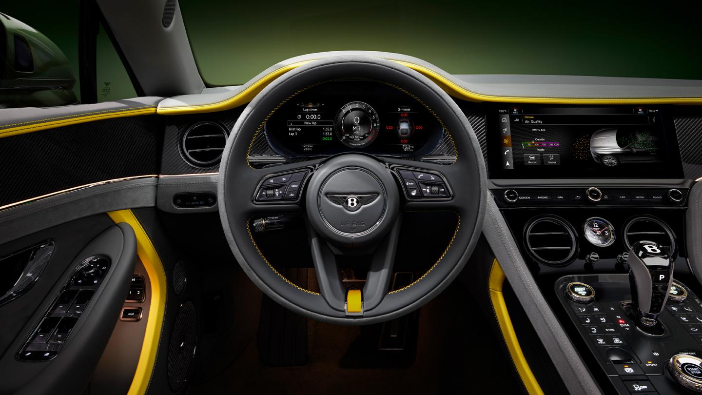Close up of the steering wheel in the new Bentley Continental GTC Speed featuring Gravity Grey main hide and Signal Yellow secondary hide accents