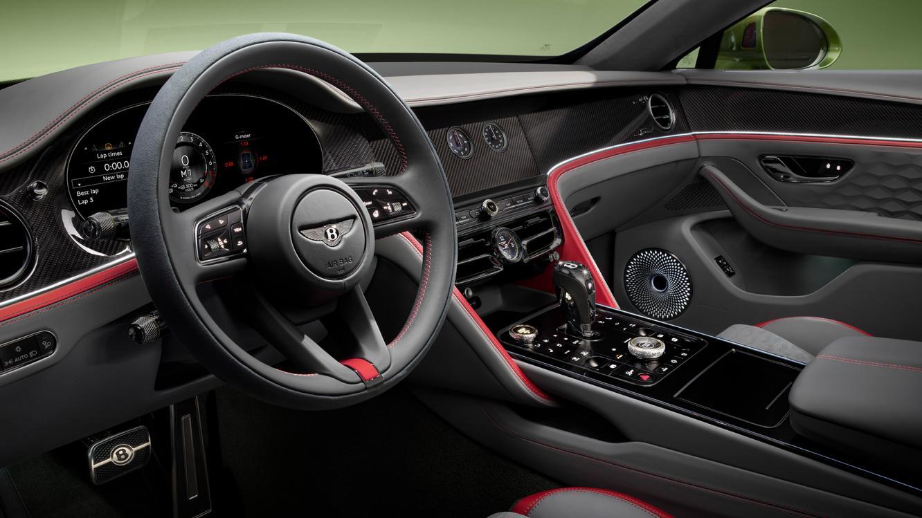 Driver side view of Bentley Flying Spur with steering wheel in view - featuring duo tone Beluga and Hotspur hides and 12.3 inch infotainment touch screen.