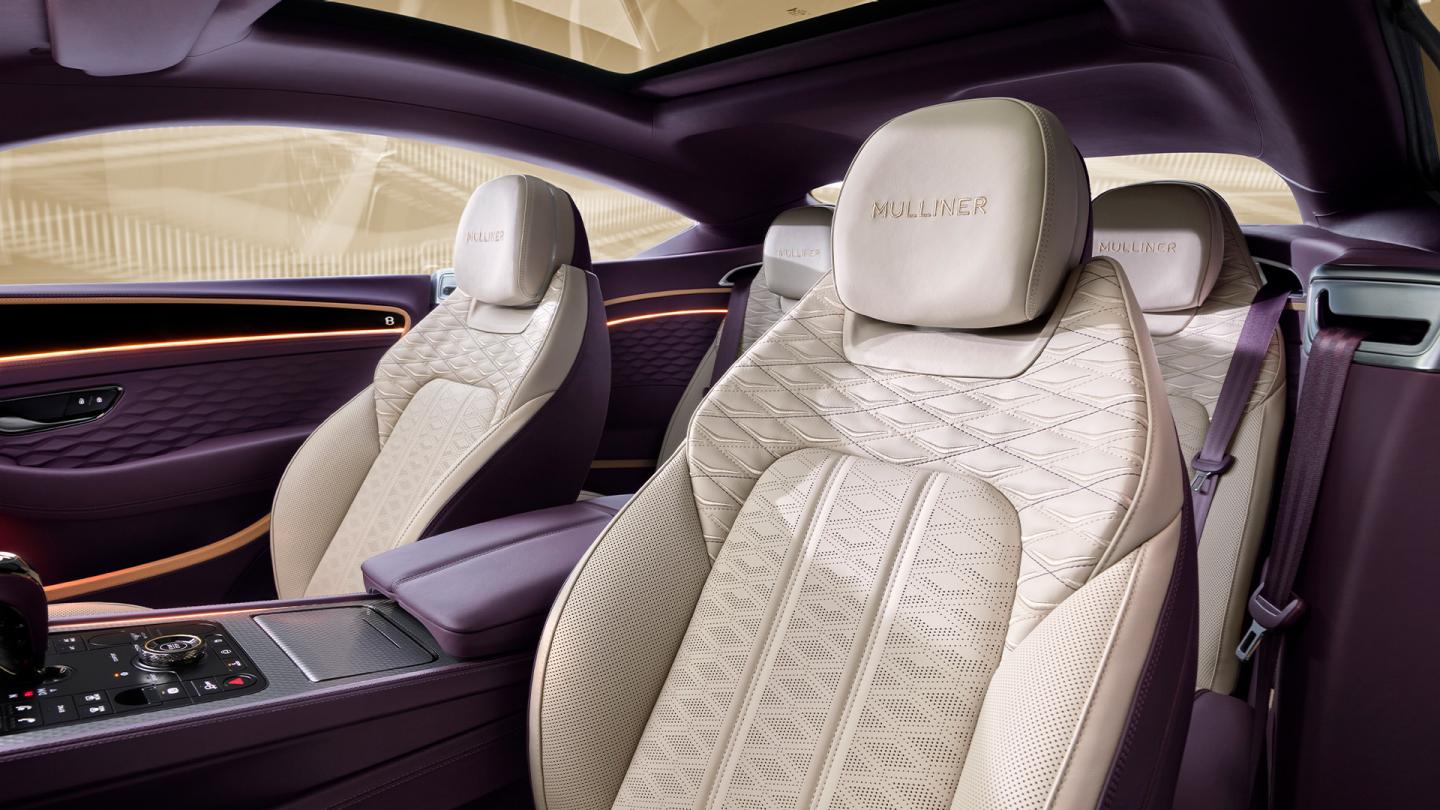 The front cabin of the new hybrid Bentley Continental GT Mulliner with a exclusive Mulliner colour split with Linen main hide and Damson secondary hide