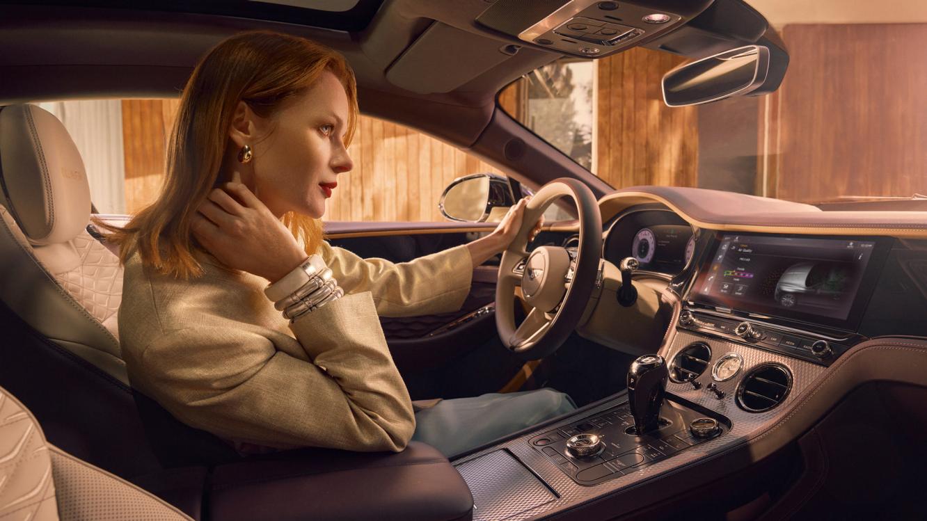 Model sitting in the drivers seat of the new Bentley Continental GT Mulliner with linen main hide and Damson secondary hide