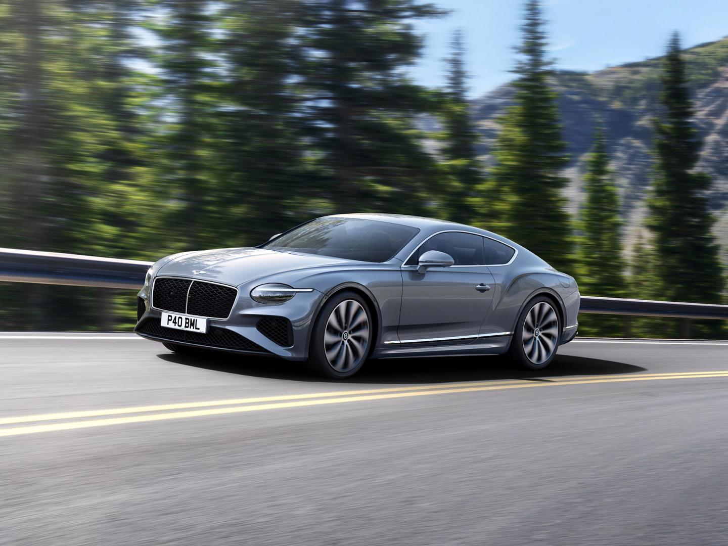 Front three quarter of the new hybrid Bentley Continental GT in a Moonbeam exterior featuring 22" directional wheels