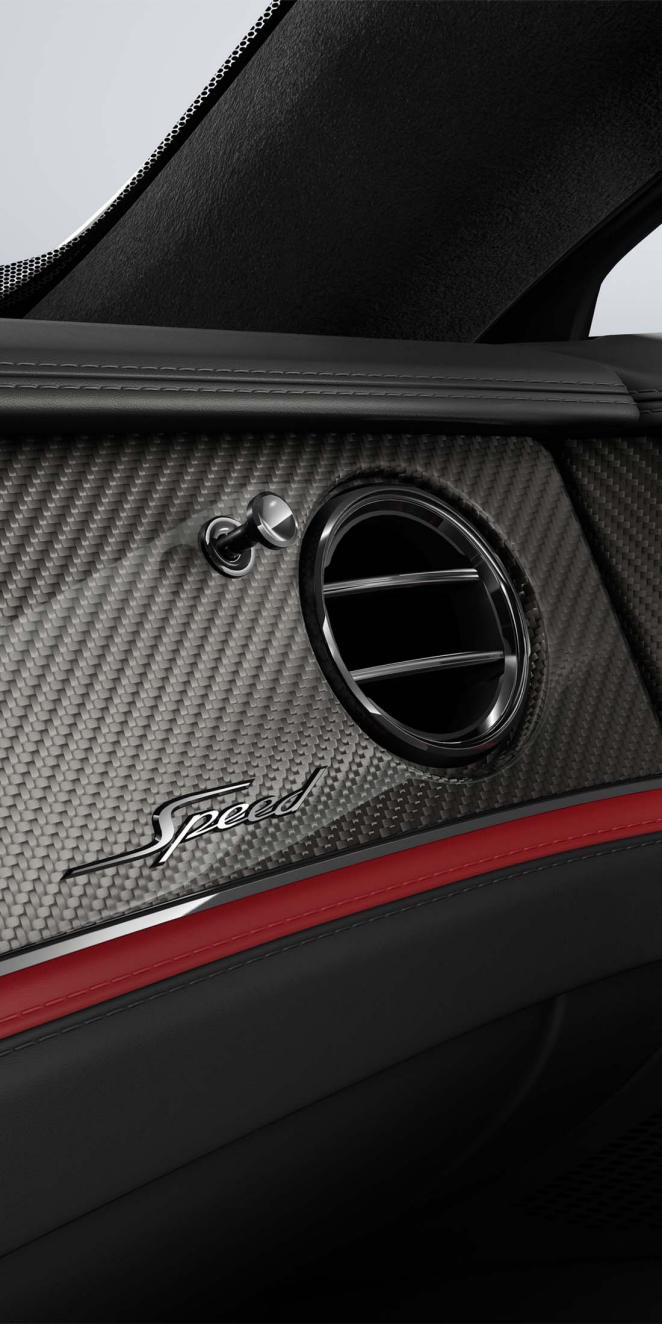 Close-up of the High Gloss Carbon Fibre veneer and air conditioning vent inside the Bentley Flying Spur Speed.