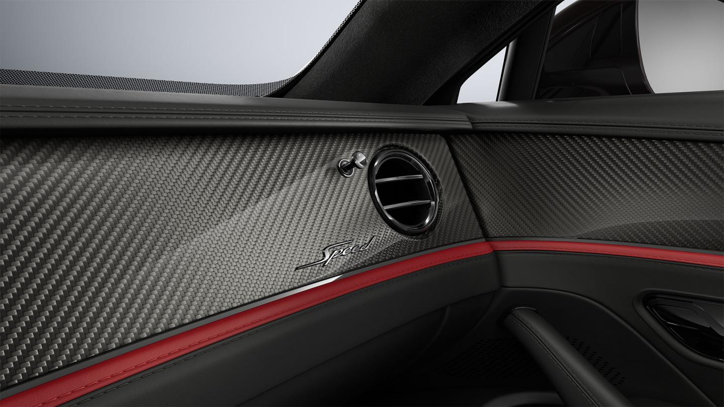 Close-up of the High Gloss Carbon Fibre veneer and air conditioning vent inside the Bentley Flying Spur Speed.