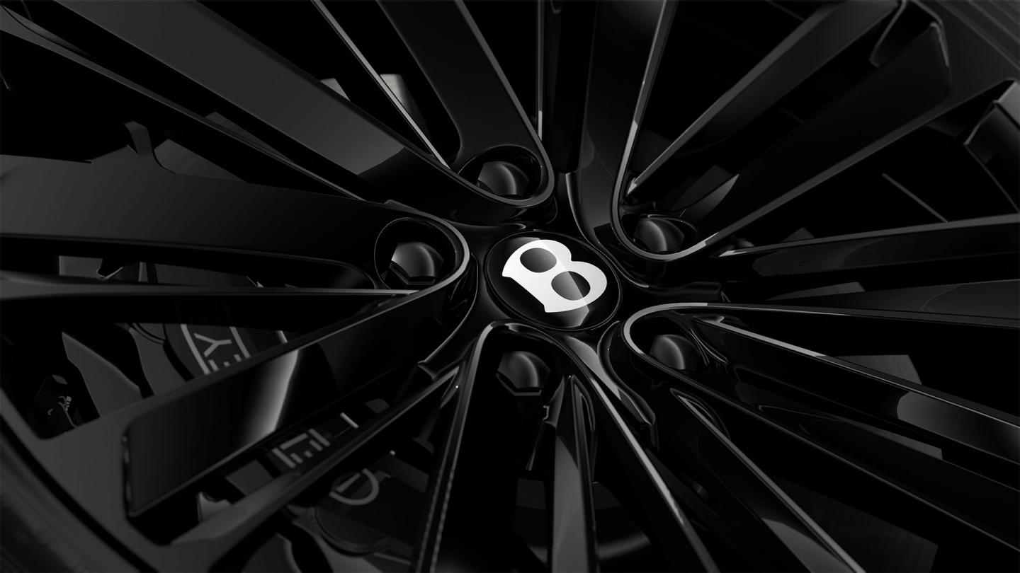 Close-up of the Bentley Flying Spur Speed 22" Speed Wheel painted in black.