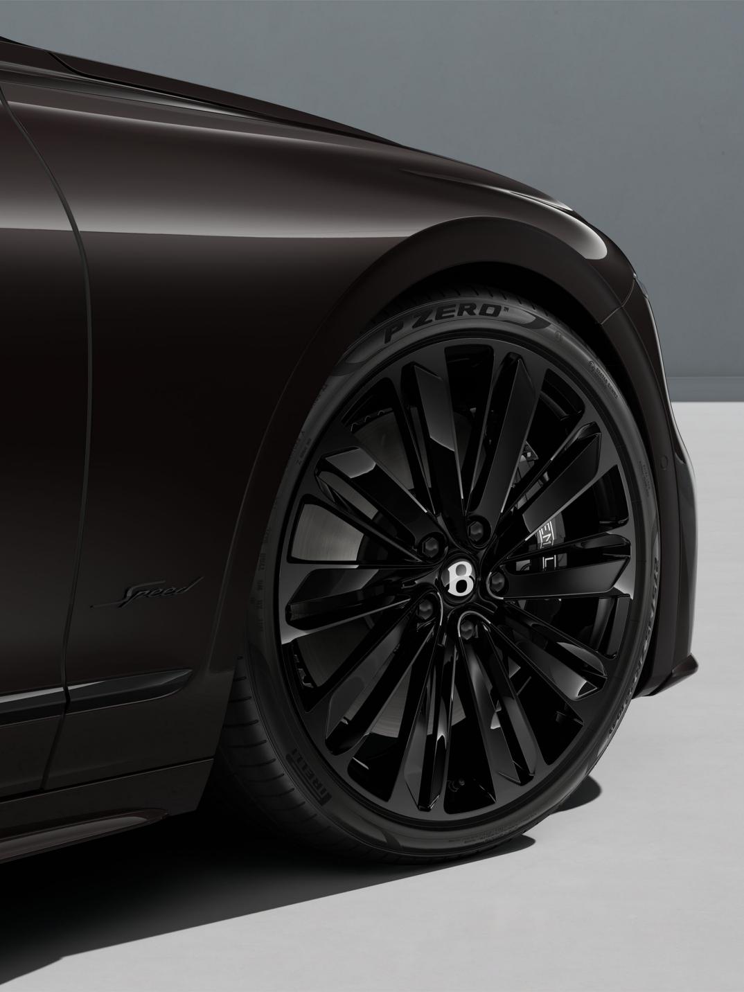 Close-up of the Bentley Flying Spur Speed 22" Speed Wheel painted in black.