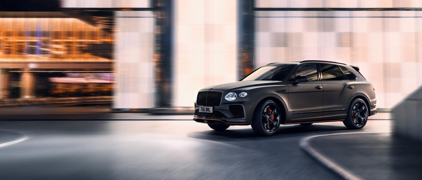 Bentayga S Black Edition in Satin paint driving in an urban environment