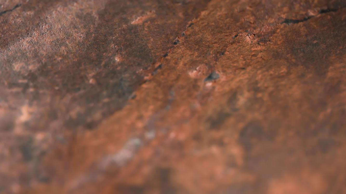 Detailed textured view of red stone.